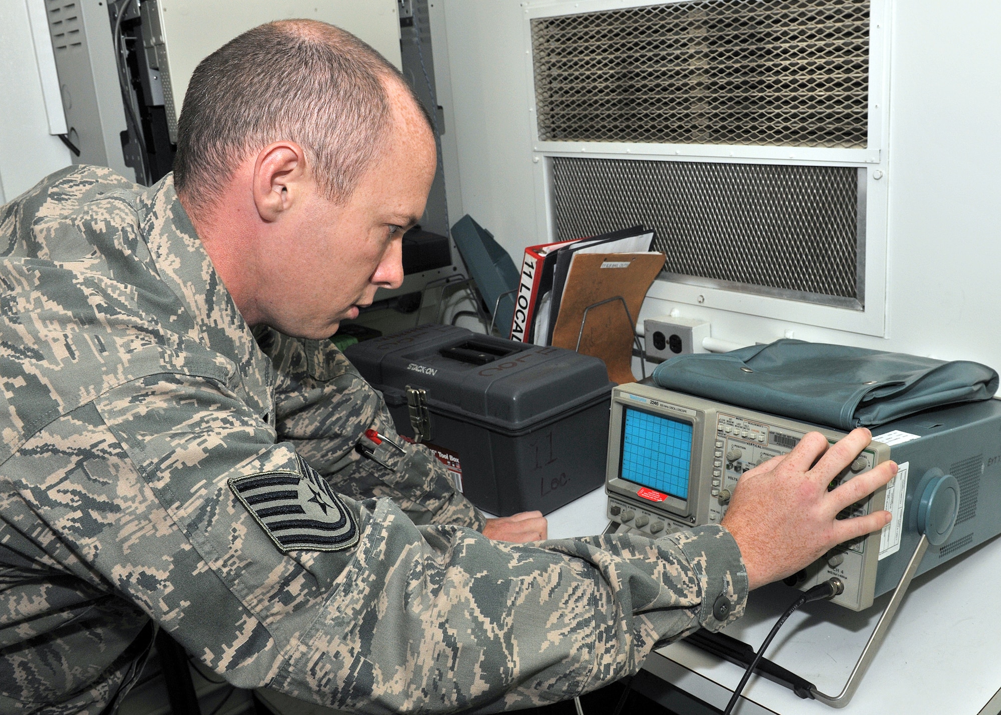 RAF MILDENHALL, England -- Tech. Sgt. Jonathan Montgomery, 100th Communications Squadron Airfield Systems shift lead, uses an oscilloscope to calibrate a signal on a localizer during a preventive maintenance inspection here Aug. 17, 2011.  A localizer transmits signals that allow incoming aircraft to land in all weather conditions.  (U.S. Air Force photo/Staff Sgt. Tabitha M. Lee)