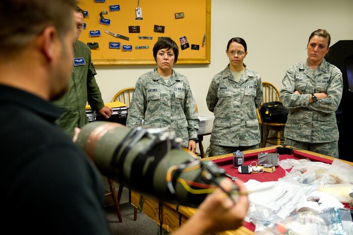 Airmen 1st Class Jodi Martinez, Brandi Hanson and Angela Setliff learn about the forensics involved with Improvised Explosive Devices during the Battlefield Forensics training course at Joint Base Charleston - Air Base Aug. 16, 2011. (U.S. Air Force photo by Myles Cullen)