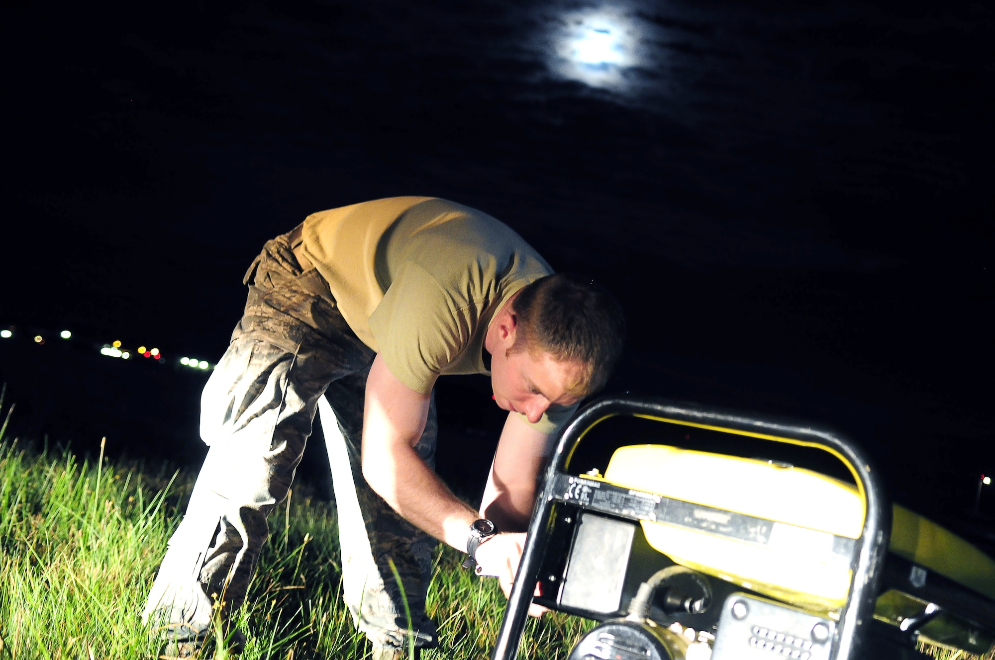 Airman 1st Class Michael Bean, 786th Civil Engineer Squadron electric power production specialist, operates a generator to pump water from the airfield lighting vaults at Ramstein Air Base, Germany, Aug.15, 2011. The water was pumped from the vaults to support the maintenance and repair of the airfield lighting system on the Ramstein runways, taxiways and flightline. (U.S. Air Force photo by Staff Sgt. Travis Edwards)