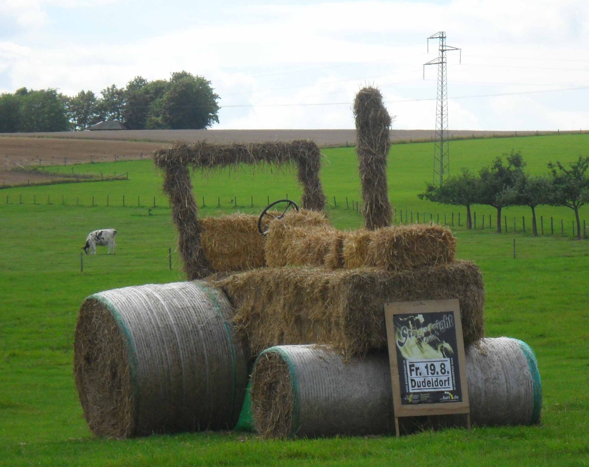 This tractor, located in a grass field on the B-50 between the base and the city of Bitburg, was built from straw piles by local Dudeldorf residents. The tractor announces the community’s traditional Krautwisch or herb festival Aug. 19-21. Among the highlights of the fest are a music party Aug. 21 and a tractor parade the evening of Aug. 22. The entry cost to the music shows range from 6 to 12 Euro. Free entertainment is provided throughout the fest. Food and beverages will be available at cost. (U.S. Air Force photo/Iris Reiff)