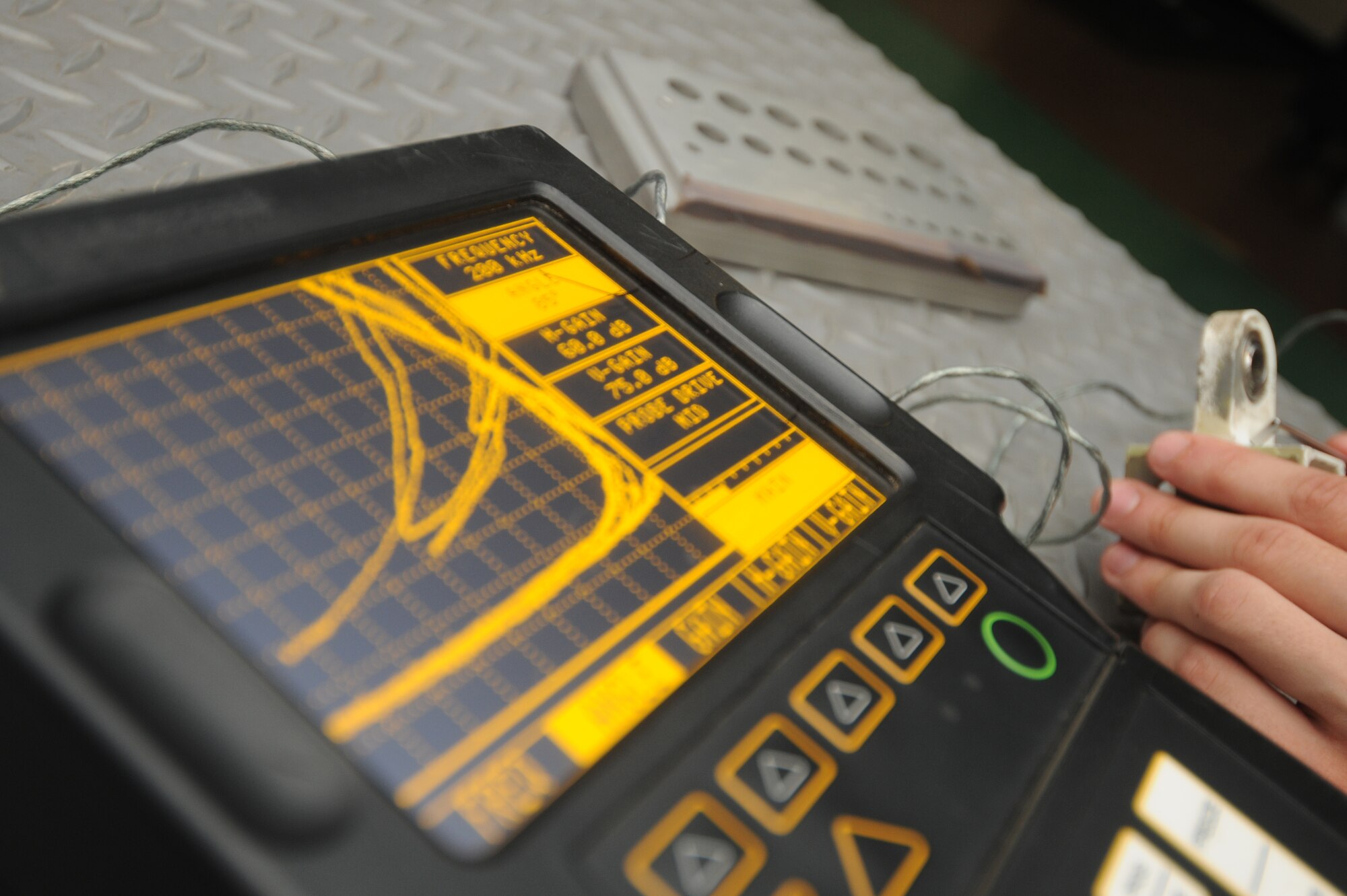 KUNSAN AIR BASE, Republic of Korea -- Senior Airman Benjamin Anderson,
8th Maintenance Squadron nondestructive inspection technician, uses an
Eddy Current Nortec 2000D and demonstrates how it detects flaws here
Aug. 17.  The Eddy Current Nortec 2000D is one of many instruments the
nondestructive inspection team uses to detect minute flaws in aircraft
materials.  (U.S. Air Force photo/Staff Sgt. Rasheen Douglas)


