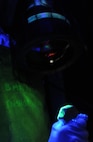 KUNSAN AIR BASE, Republic of Korea -- Senior Airman Kelli Tompkins, 8th
Maintenance Squadron nondestructive inspection technician, uses an
ultraviolet light and a special dye to detect flaws during an inspection
of aircraft components here Aug. 17.  The nondestructive inspection team
inspects aircraft parts, checking for stress and hairline fractures in
the aircraft material.  (U.S. Air Force photo/Staff Sgt. Rasheen Douglas)

