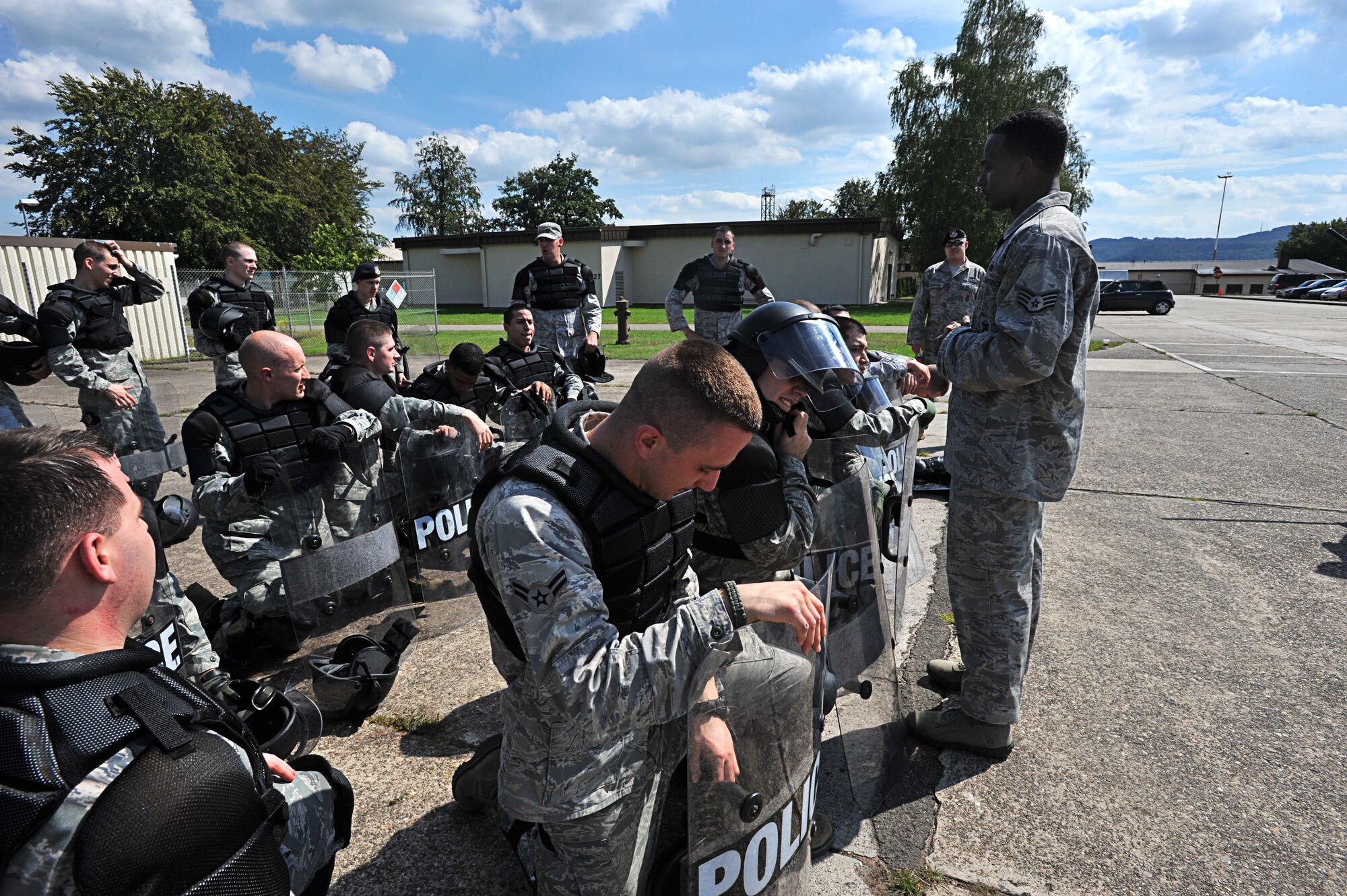 Air Force 86th Security Forces Squadron members debrief after a simulated protest exercise during confrontation management class at Ramstein Air Base, Germany, Aug. 16, 2011. The 86th SFS trains for confrontation management (riot control) to defend the base populace and its resources from violent protestors; it is also a core task of SF members. (U.S. Air Force photo by Airman 1st Class Desiree Esposito)