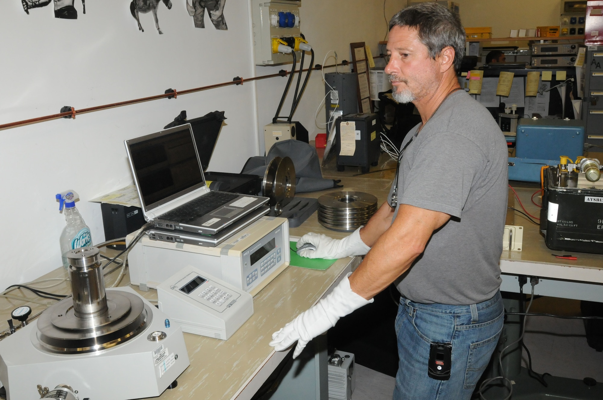 Jeffery Logsdon uses a primary pressure sender to calibrate a pressure controller Aug. 16 at Aviano Air Base, Italy. The primary pressure sender is the standard calibration for all of Europe, and any piece of equipment that measures pressure can be traced back to this machine. Logsdon is assigned to the 31st Maintenance Squadron precision measurement equipment laboratory as a technical measurement diagnostics equipment technician. (U.S. Air Force photo/Airman LaVel Sterling)