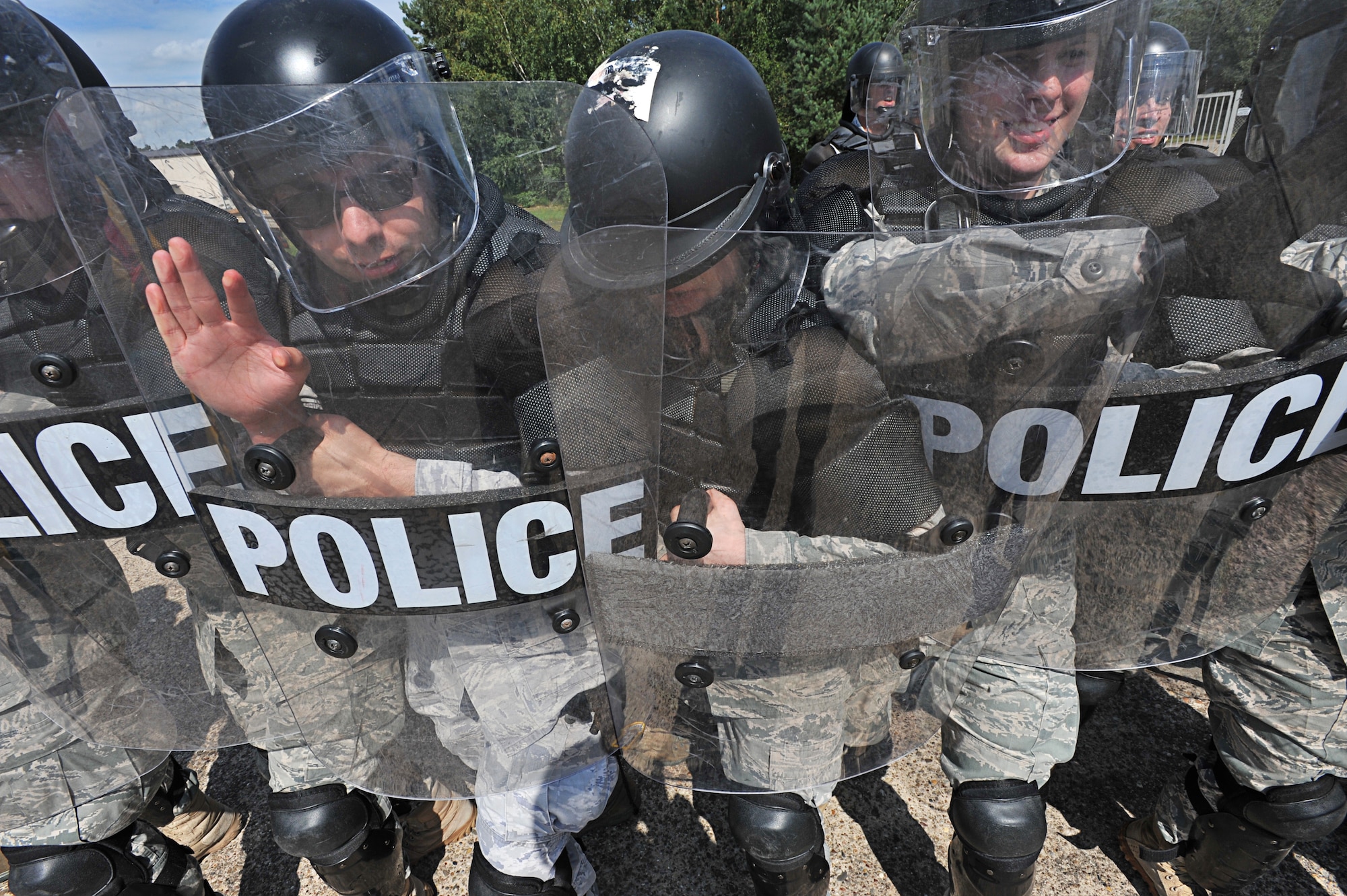 Air Force 86th Security Forces Squadron members participate in a simulated protest exercise during confrontation management class at Ramstein Air Base, Germany, Aug. 16, 2011. The 86th SFS trains for confrontation management (riot control) to defend the base populace and its resources from violent protestors; it is also a core task of SF members. (U.S. Air Force photo by Airman 1st Class Desiree Esposito)