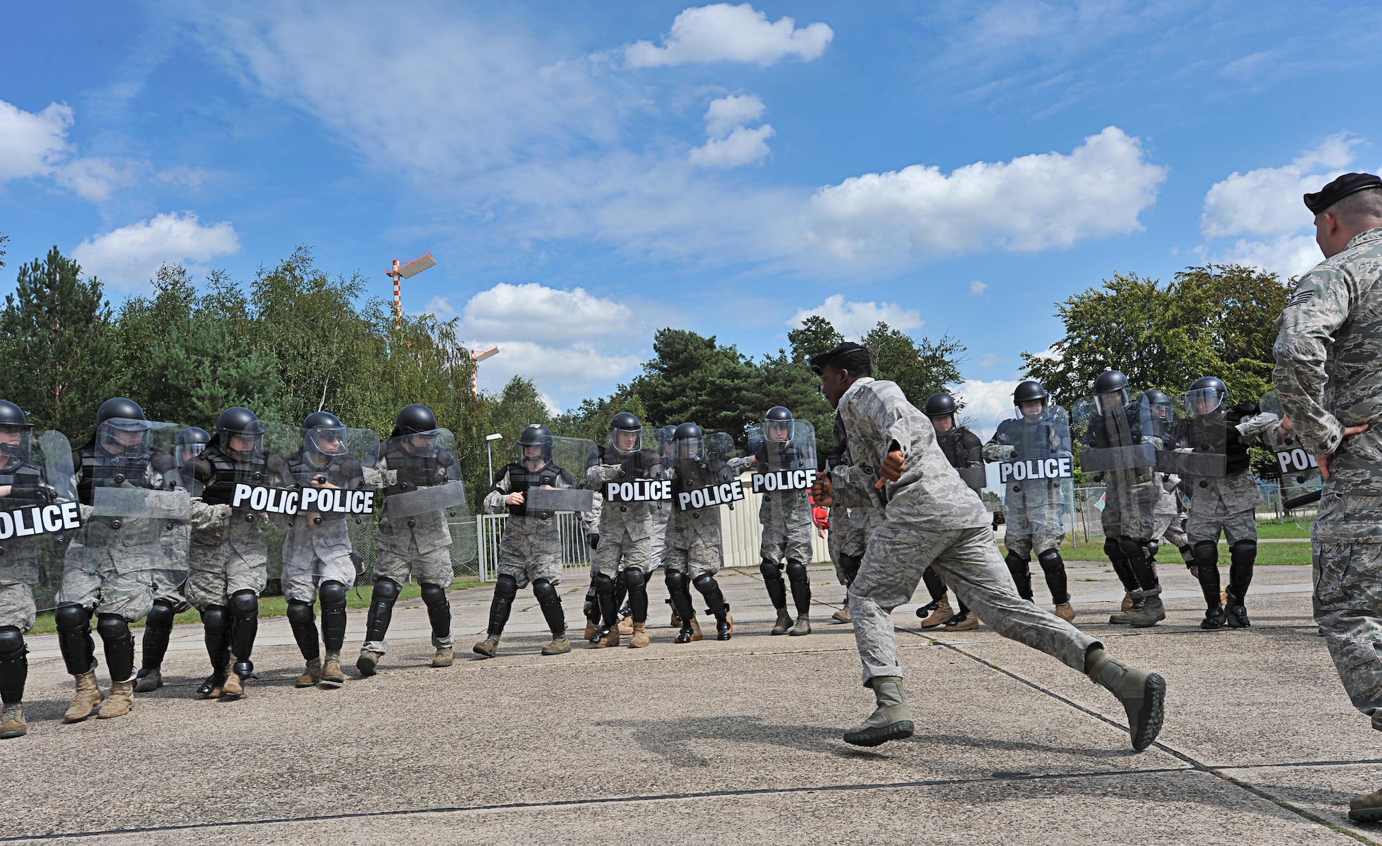 Air Force Staff Sgt. Eugene Harrison, 86th Security Forces Squadron training instructor, simulates a protestor during confrontation management class at Ramstein Air Base, Germany, Aug. 16, 2011. The 86th SFS trains for confrontation management (riot control) to defend the base populace and its resources from violent protestors; it is also a core task of SF members. (U.S. Air Force photo by Airman 1st Class Desiree Esposito)