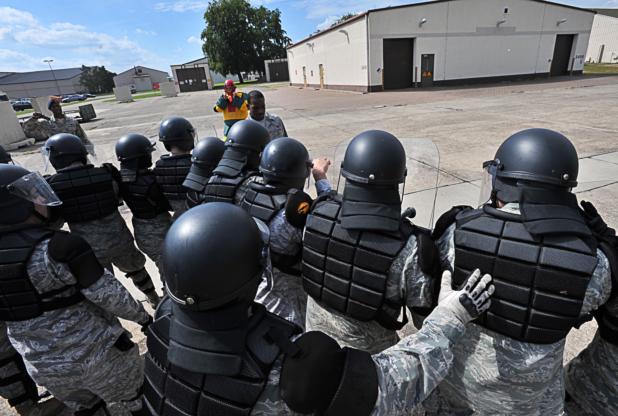 Air Force 86th Security Forces Squadron members participate in a simulated protest exercise during confrontation management class at Ramstein Air Base, Germany, Aug. 16, 2011. The 86th SFS trains for confrontation management (riot control) to defend the base populace and its resources from violent protestors; it is also a core task of SF members. (U.S. Air Force photo by Airman 1st Class Desiree Esposito)