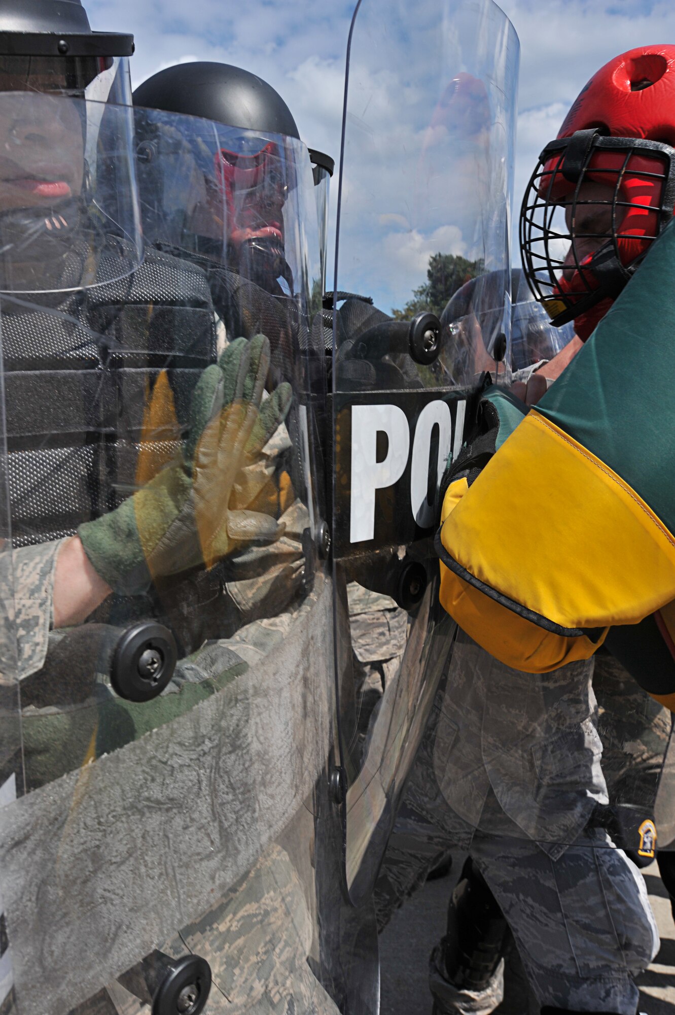 Air Force 86th Security Forces Squadron members participate in a simulated protest exercise during confrontation management class at Ramstein Air Base, Germany, Aug. 16, 2011. The 86th SFS trains for confrontation management (riot control) to defend the base populace and its resources from violent pedestrians; it is also a core task of SF members. (U.S. Air Force photo by Airman 1st Class Desiree Esposito)