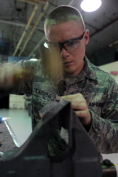 KUNSAN AIR BASE, Republic of Korea – Senior Airman Adam Labenne, 8th Maintenance Squadron aircraft structural maintenance journeyman, fabricates a beef-up plate for an egress seat, here Aug. 11. Airmen from the aircraft structural maintenance perform maintenance on external sheet metal, internal framework, composites, fiberglass and plastic, as well as tubing and cable assemblies on aircraft. (U.S. Air Force photo/Senior Airman Brittany Y. Bateman)