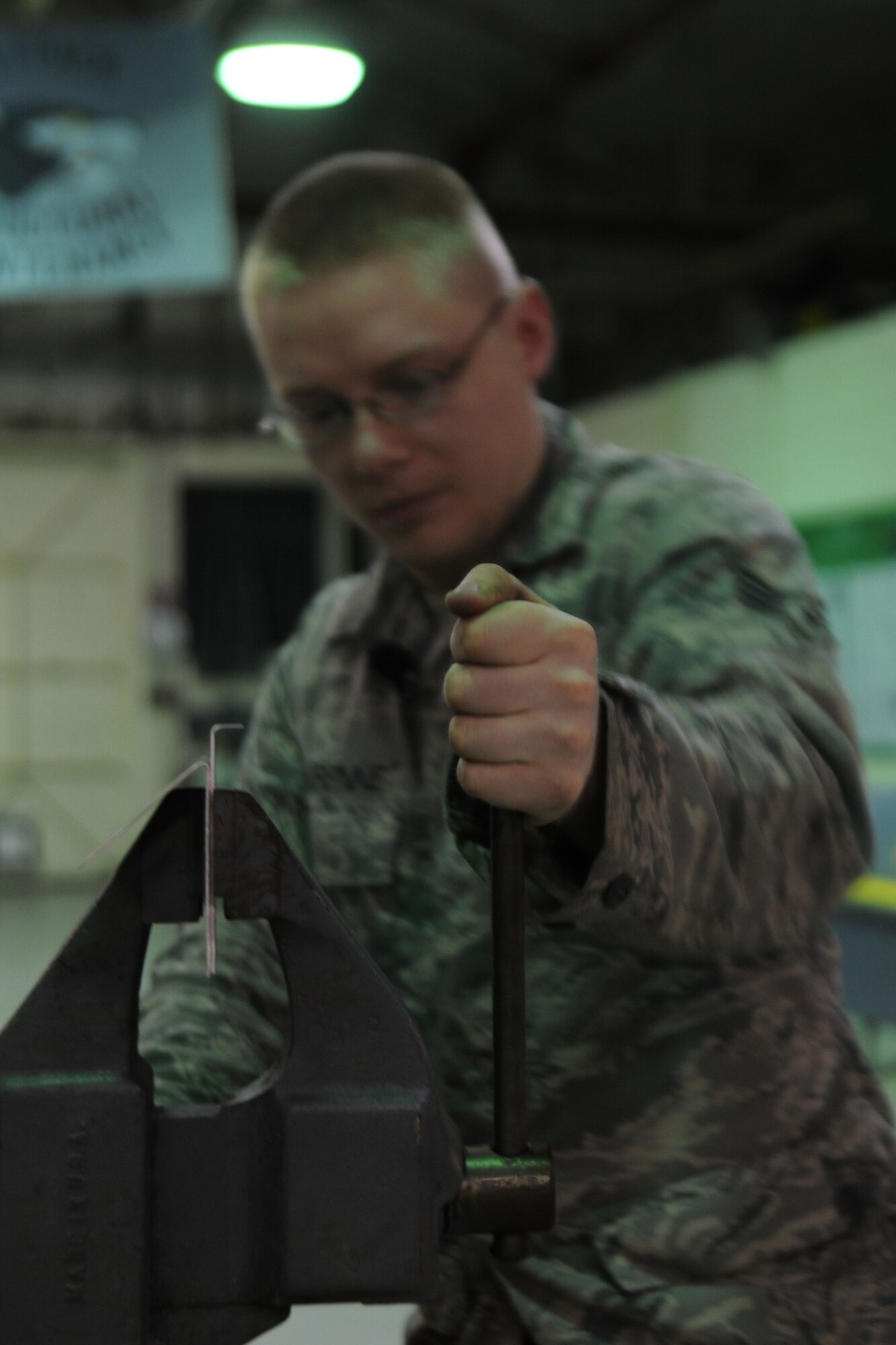 KUNSAN AIR BASE, Republic of Korea -- Senior Airman Adam Labenne, 8th Maintenance Squadron aircraft structural maintenance journeyman, tightens a vice on a beef-up plate during fabrication here Aug. 11. Airmen from the aircraft structural maintenance perform maintenance on external sheet metal, internal framework, composites, fiberglass and plastic, as well as tubing and cable assemblies on aircraft. (U.S. Air Force photo/Senior Airman Brittany Y. Bateman)