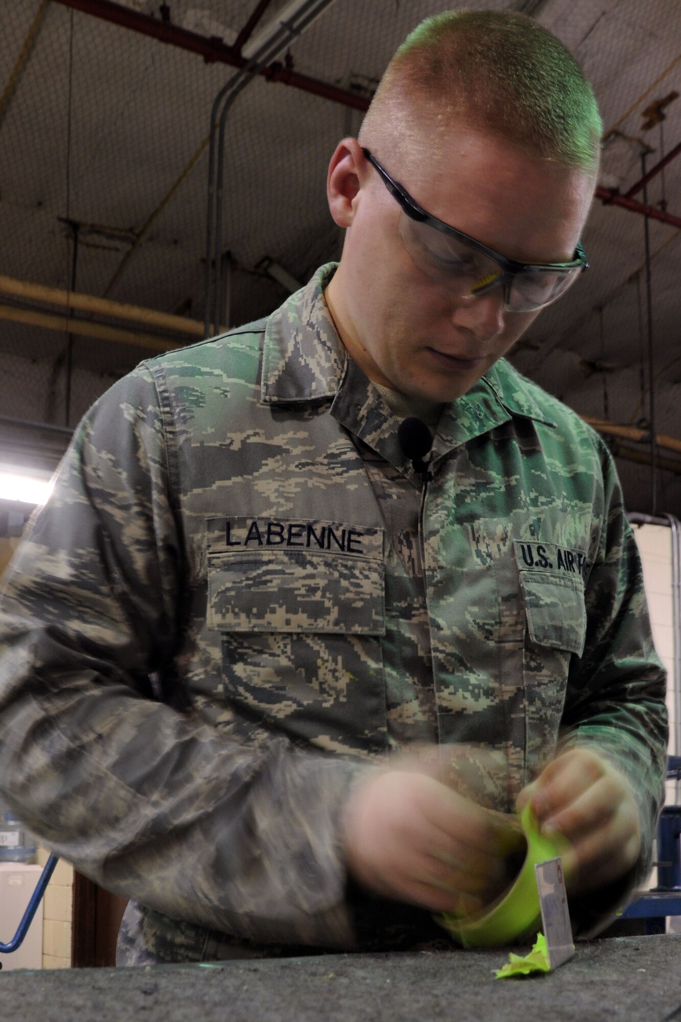 KUNSAN AIR BASE, Republic of Korea -- Senior Airman Adam Labenne, 8th Maintenance Squadron aircraft structural maintenance journeyman, places tape around a beef-up plated during fabrication here Aug. 11. Airmen assigned to this flight are responsible for the structural maintenance of all aircraft assigned to Kunsan AB.   (U.S. Air Force photo/Senior Airman Brittany Y. Bateman)
