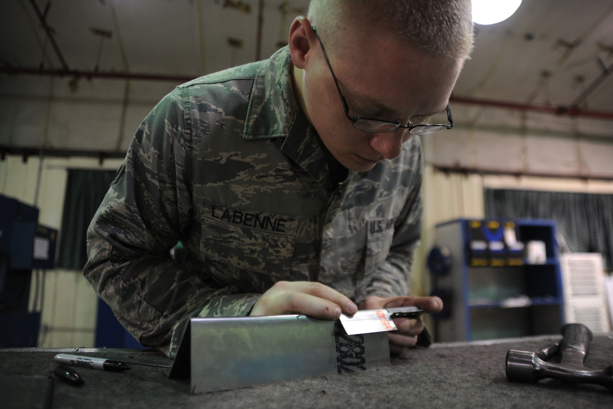 KUNSAN AIR BASE, Republic of Korea -- Senior Airman Adam Labenne, 8th Maintenance Squadron aircraft structural maintenance journeyman, fabricates a beef-up plate for an egress seat, here Aug. 11. Airmen from the aircraft structural maintenance perform maintenance on external sheet metal, internal framework, composites, fiberglass and plastic, as well as tubing and cable assemblies on aircraft. (U.S. Air Force photo/Senior Airman Brittany Y. Bateman) 