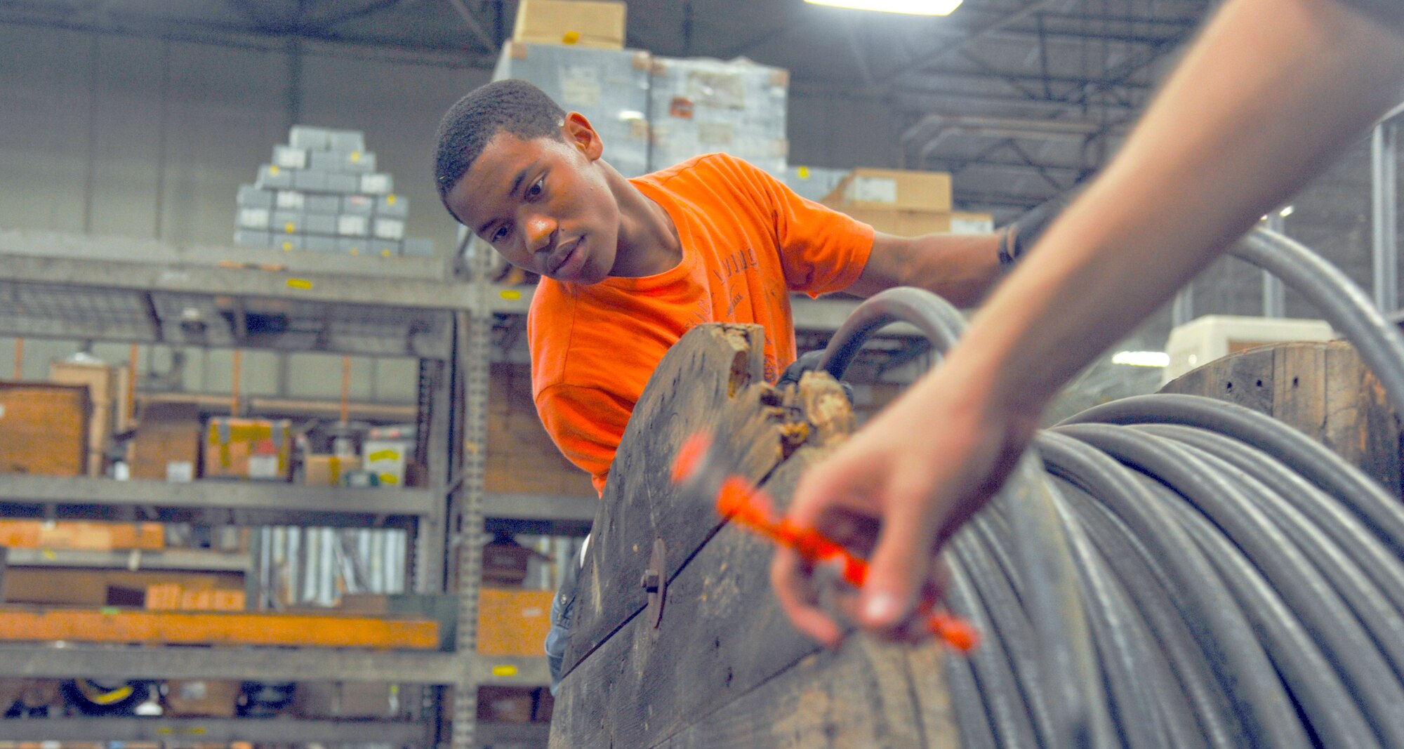 YOKOTA AIR BASE, Japan -- Tristan Braxton, a Yokota High School student participating in the summer hire program, takes inventory of cables at the 374th Communications Squadron warehouse at Yokota Air Base, Japan, Aug. 4, 2011. The summer hire program is funded through the 374th Airlift Wing and gives students a chance to experience the work force. (U.S. Air Force photo/Airman 1st Class Krystal M. Garrett)