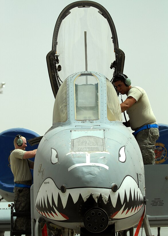 U.S. Air Force Senior Airman Christopher Shroyer, left, and Staff Sgt. Rafael Medina III, right, attempt to isolate an ongoing issue with the navigation system of an A-10C Thunderbolt II on Kandahar Airfield, Afghanistan, Aug. 8, 2011. Shroyer, an avionics journeyman, and Medina, an avionics craftsman, are both assigned to the 23rd Aircraft Maintenance Squadron.