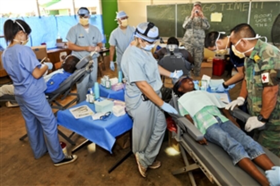 U.S. service members treat patients during a New Horizons 2011 training exercise in Brownsweg, Suriname, Aug. 15, 2011.The service members are assigned to the 59th Dental Training Squadron at Lackland Air Force Base, Texas.