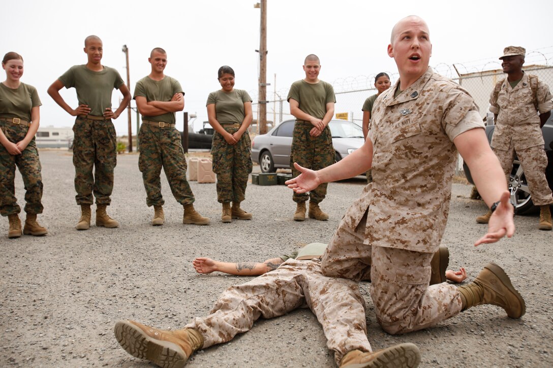 Petty Officer 2nd Class Devin L. Turner, hospital corpsman, 15th Marine Expeditionary Unit, explains the importance of pressure points before applying a tourniquet to a group of cadets with El Camino High School's Junior Reserve Officer Training Corps at the MEU's armory in Camp Del Mar, Aug. 16. Marines and sailors of the MEU educated a portion of the school's JROTC where they spent two days on base living like Marines to better their understanding of the operational side of the Marine Corps. Turner, 28, is a native of Fresno, Calif.