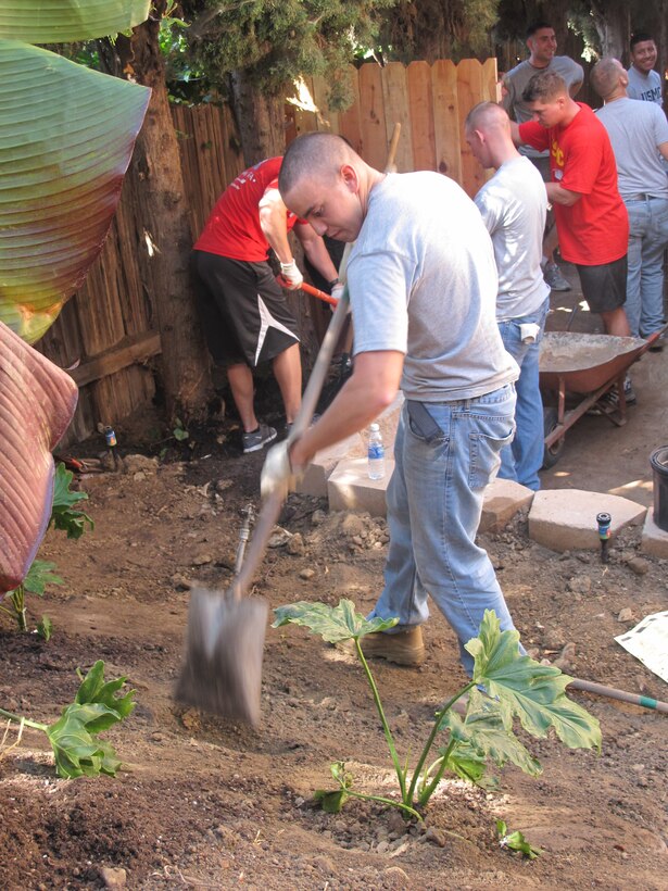 Pfc. Hudson Hawkins, disbursing clerk, Disbursing, Service Company, Combat Logistics Regiment 17, 1st Marine Logistics Group, landscapes while volunteering with Costa Mesa Home Depot, ‘Team Depot,’ in San Juan Capistrano, Calif., Aug. 18. ‘Team Depot’ is an organization that new emphasizes serving US military veterans who are in need of assistance repairing and renovating their homes.