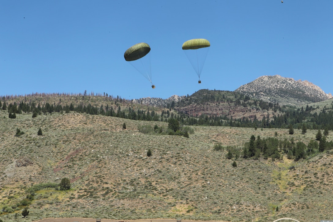Marine Aerial Refueler Transport Squadron 352 pilots and crew members drop two bundles of container delivery systems filled with MREs during an aerial resupply exercise at the Marine Corps Mountain Warfare Training Center Aug. 18 2011.::r::::n::