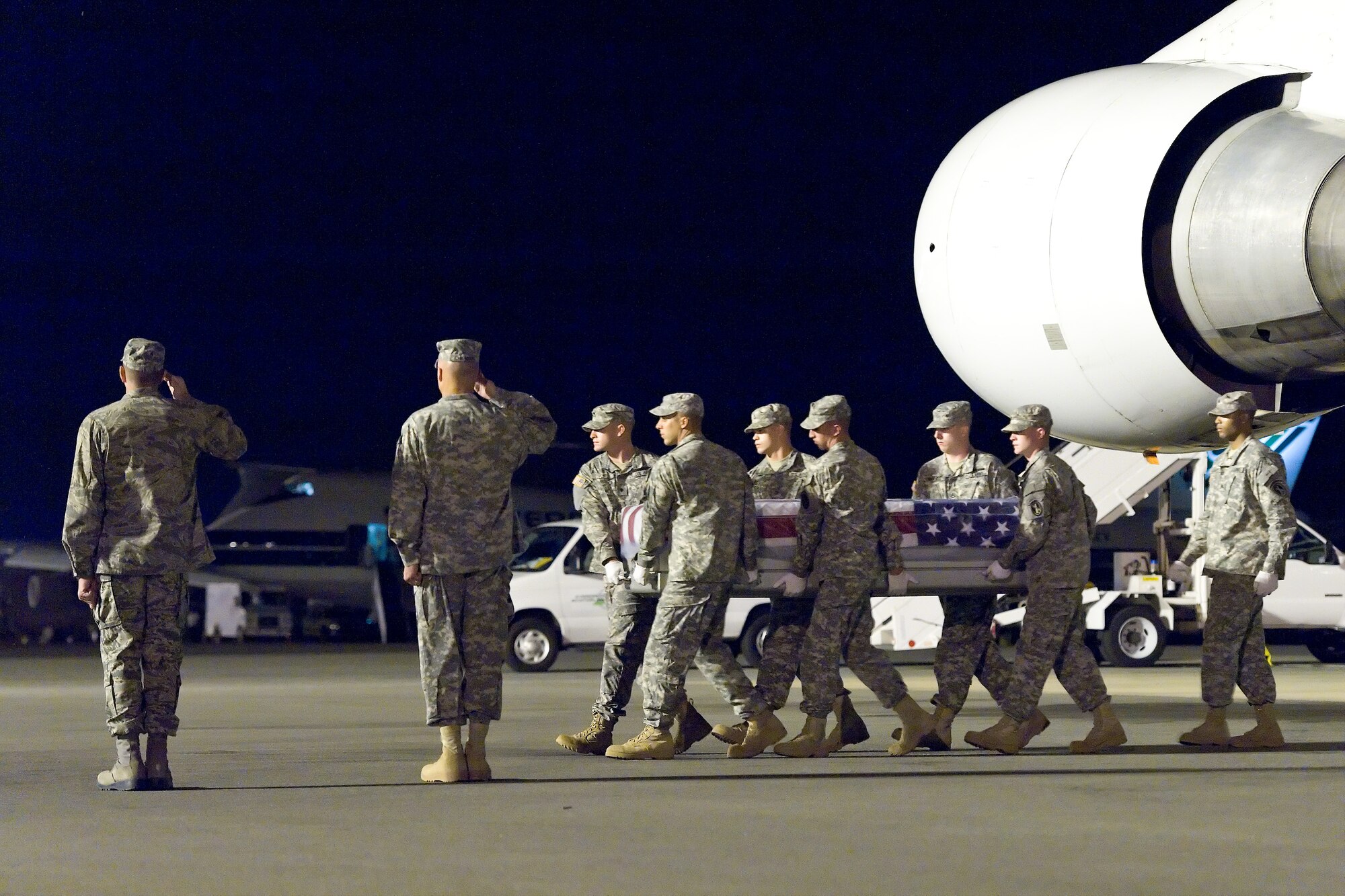 A U.S. Army carry team transfers the remains of Army Spc. Dennis G. Jensen, of Vermillion, S.D., at Dover Air Force Base, Del., Aug. 18, 2011.  Jensen was assigned to the 153rd Engineer Battalion, 196th Maneuver Enhancement Brigade, Sioux Falls, S.D. (U.S. Air Force photo/Roland Balik)