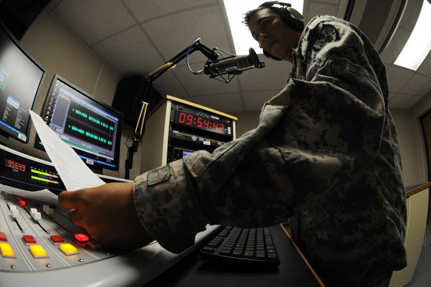 KUNSAN AIR BASE, Republic of Korea -- Army Sgt. Jose Ramirez, American Forces Network Korea  broadcast producer, produces a radio spot here Aug. 17. AFN Kunsan provides information through radio spot production, advertising and informing Wolf Pack members about: safety trends, morale, welfare and recreation events and local base policies and procedures. (U.S. Air Force photo/Senior Airman Brittany Y. Bateman)