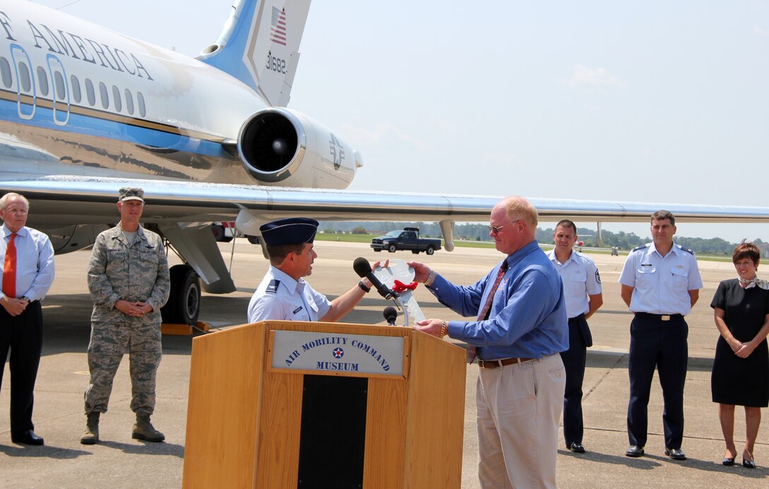 Col. William Edwards, 932nd Airlift Wing commander, hands the ceremonial C9-C key to Michael Leister, museum director of the .Air Mobility Command  Museum. The C-9C landed at Dover  Air  Force Base, Del. on August 18, for its  addition to the AMC Museum. The C-9C has flown our nations' civilian and military leaders  across the world since 1975. The aircrew for  the final flight was  Lt. Col. Rick Eccher, pilot; and Lt. Col Bryan Birchem, co-pilot. (U.S. Air Force photo/Tech. Sgt. Dan Oliver)