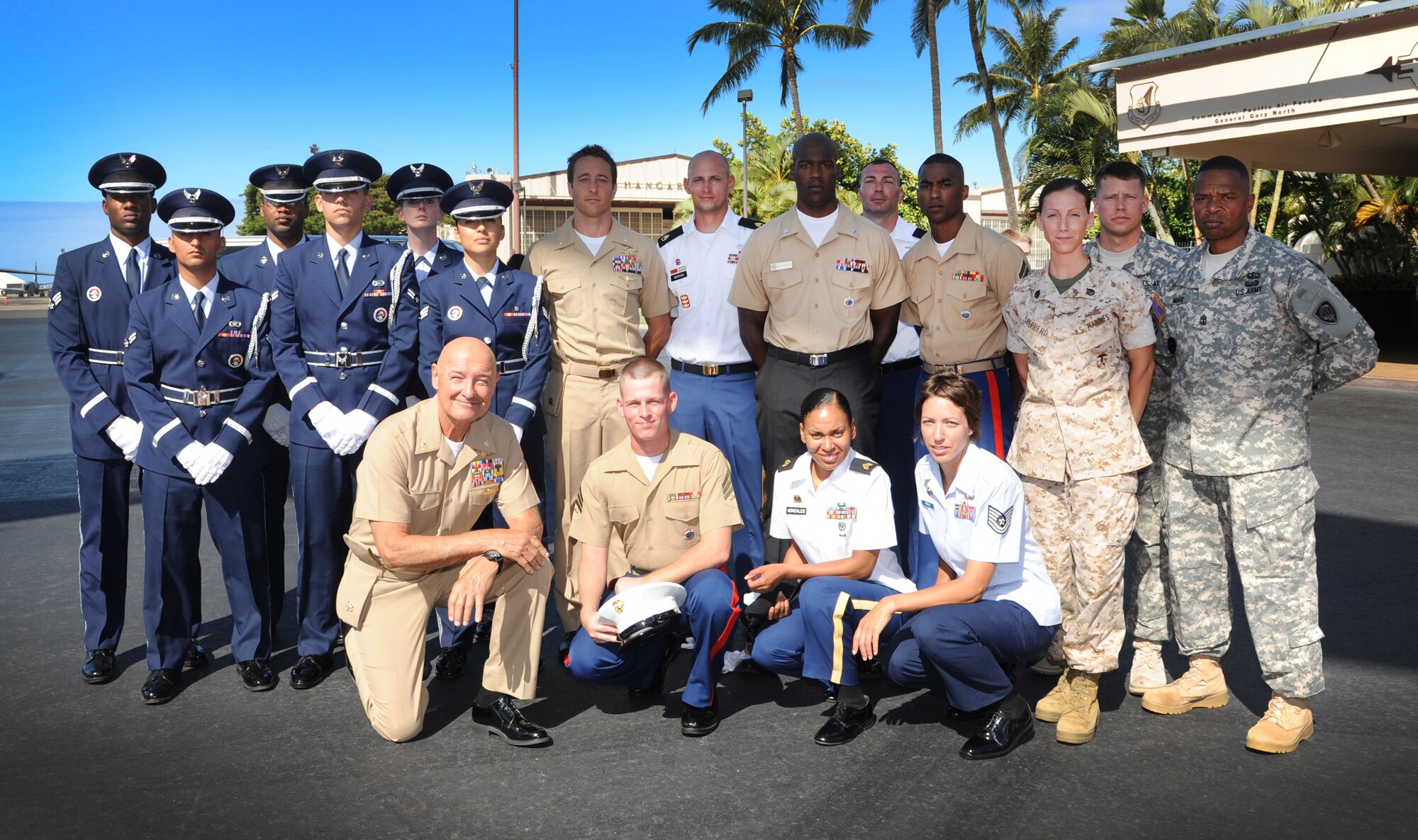 Actors from "Hawaii Five-0" pose for a photograph with Joint Base Pearl Harbor-Hickam Air Force honor guard and the Joint POW/MIA Accounting Command honor guard Aug. 17. The crew filmed a portion of an upcoming episode on the Hickam Field flightline. More than 30 Airmen, Sailors, Marines and Soldiers were selected to participate in the shoot. This is the second year that the hit CBS show has filmed on JBPHH.
