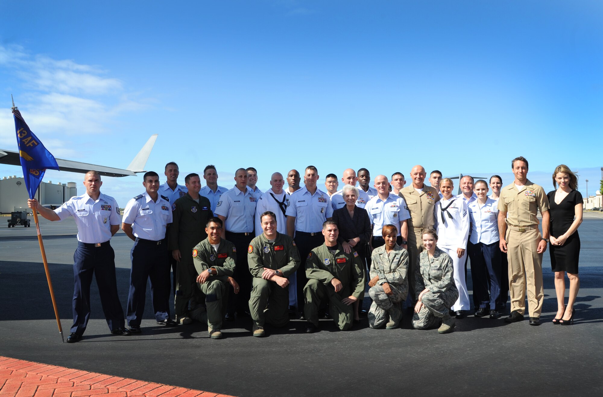 Actors from "Hawaii Five-0" pose for a photograph with members from the 15th Wing and Joint Base Pearl Harbor-Hickam Aug. 17. The crew filmed a portion of an upcoming episode on the Hickam Field flightline. More than 30 Airmen, Sailors, Marines and Soldiers were selected to participate in the shoot. This is the second year that the hit CBS show has filmed on JBPHH.