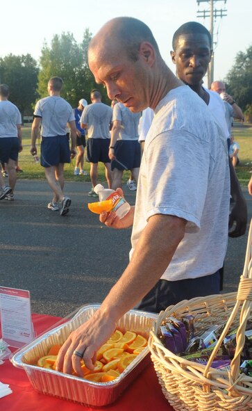 Tech. Sgt. Ryan Constantin, 2nd Logistics Readiness Squadron, reaches for orange slices after the "Back to School" fun run on Barksdale Air Force Base, La., Aug. 18. Oranges were given out to help replenish energy and vitamin C after the run. (U.S. Air Force photo/Senior Airman Kristin High)(RELEASED) 