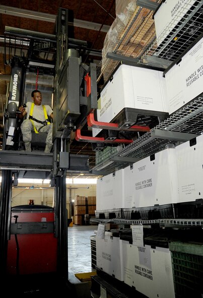 Airman 1st Class Cameron Curry, 2nd Logistics Readiness Squadron mobility and weapons section, uses a highster lift or Raymond, to bring down a crate of individual protective equipment on Barksdale Air Force Base, La., Aug. 17. The 2 LRS warehouse has several rows of IPE that are arranged by type and size for quick retrieval. (U.S. Air Force photo/Senior Airman Amber Ashcraft) (RELEASED)
