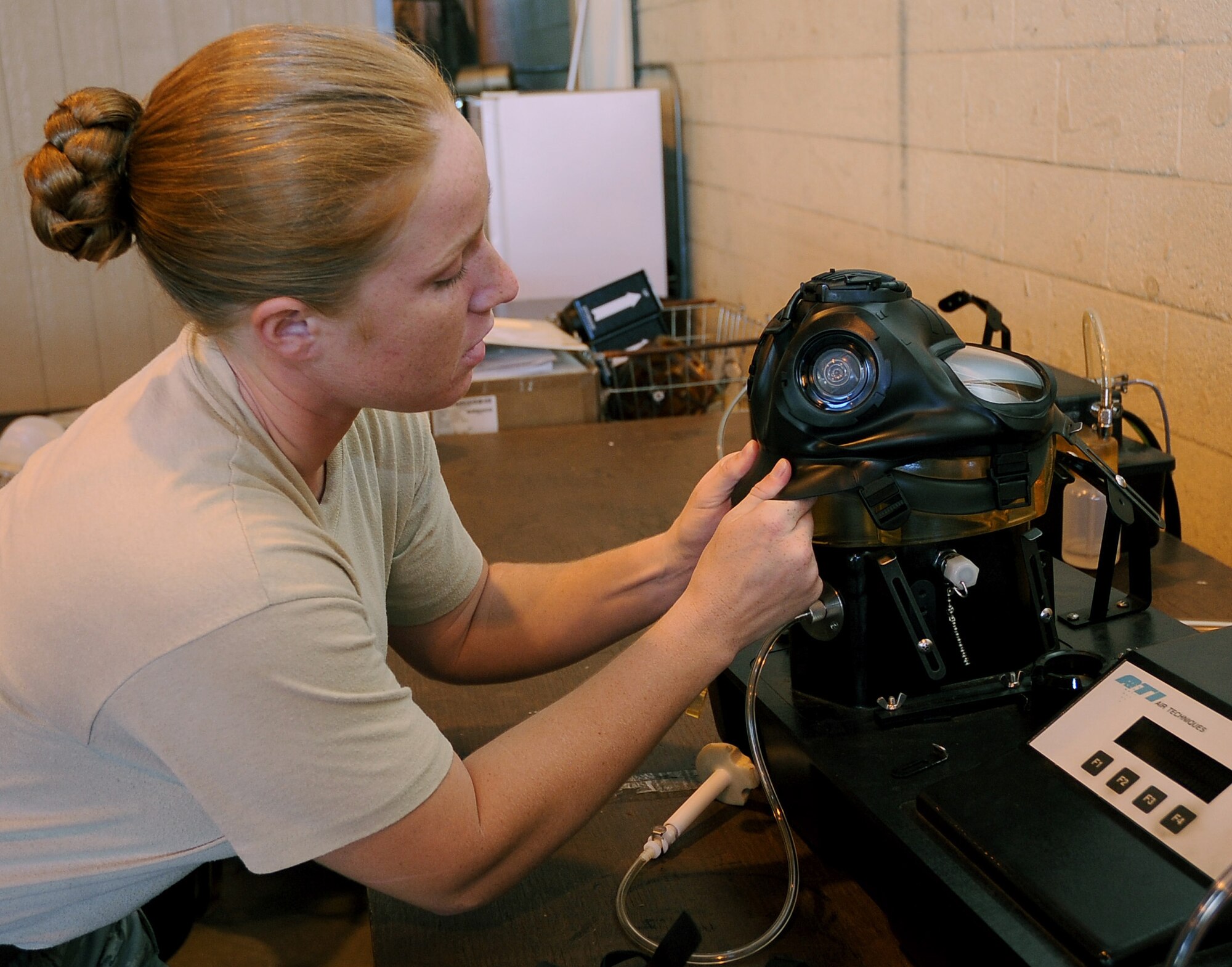 Senior Airman Sarah Lanzillo, 2nd Logistics Readiness Squadron mobility and weapons section, preps an M-50 Joint Service General Purpose Mask to be tested for proper sealing and function on Barksdale Air Force Base, La., Aug. 17. Although most of the base populace is still using the MCU-2A/P or the Mickey 2, all masks must be leak tested before being issued to Airmen. (U.S. Air Force photo/Senior Airman Amber Ashcraft) (RELEASED)