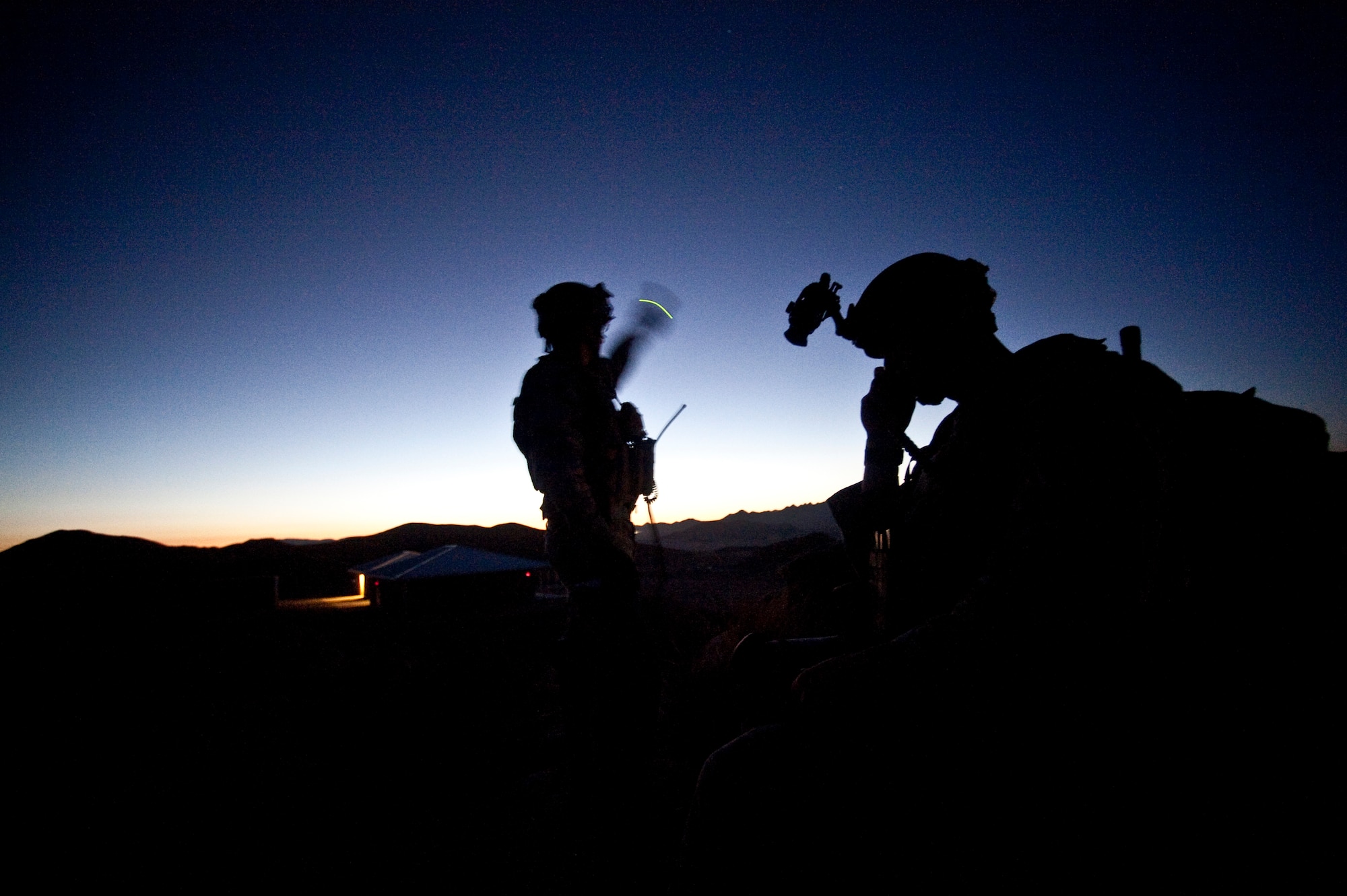 U.S. Air Force Tech. Sgt. Donald Urqhart, and Airman 1st Class Michael Pincheira, 5th Air Support Operations Squadron joint terminal attack controllers, from Fort Lewis, Wash., make contact with 55th Fighter Squadron F-16 Fighting Falcons during a Green Flag-West 11-9 close air support training exercise, Aug. 14, 2011, in the National Training Center at Fort Irwin, Calif.  JTAC Airmen train with the 12th Combat Training Squadron as part of Green Flag-West to stay proficient and prepare for upcoming deployments. (U.S. Air Force photo by Tech. Sgt. Michael R. Holzworth/Released)
