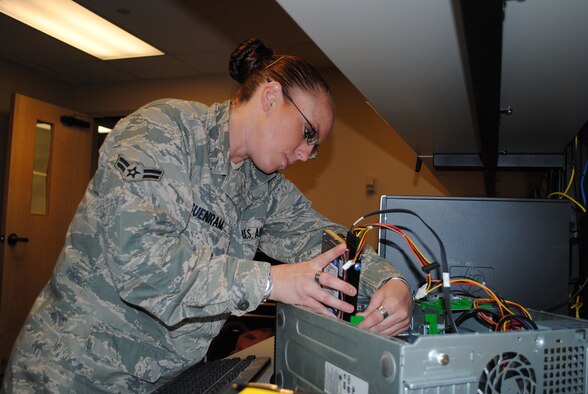 Airman 1st Class Sara Suenram, client systems technician with the 341st Communications Squadron works on installing a new hard drive.  (U.S. Air Force photo/Airman 1st Class Katrina Heikkinen)
