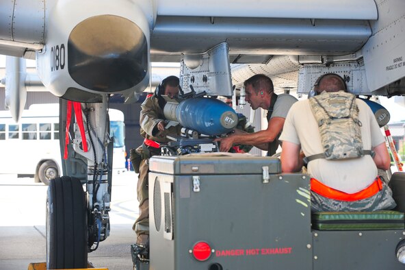 U.S. Air Force weapons load crew members from the 23rd Aircraft Maintenance Squadron load munitions onto an A-10C Thunderbolt II during a phase II operational readiness exercise at Moody Air Force Base, Ga., Aug.  17, 2011. The base conducted the phase II exercise to prepare Airmen for an operational readiness inspection scheduled for next year. (U.S. Air Force photo by Senior Airman Stephanie Mancha/Released)