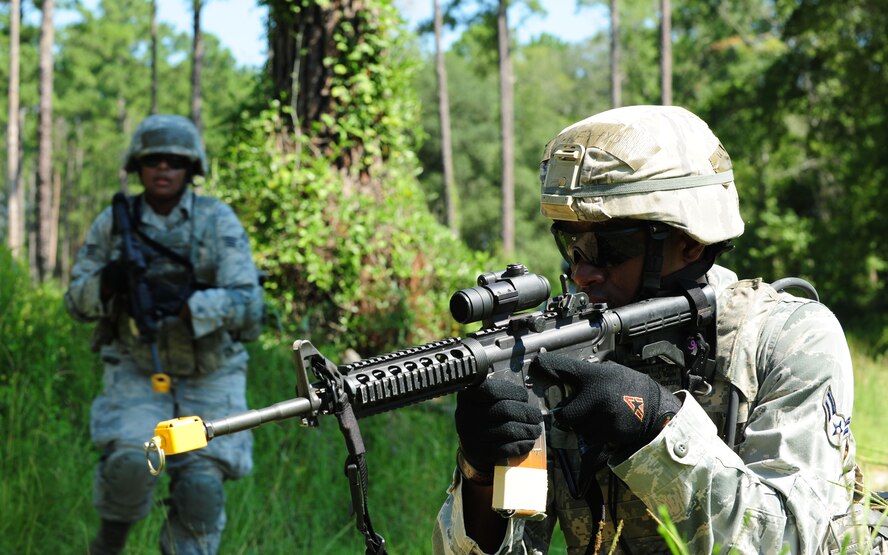 U.S. Air Force Airman 1st Class Jirah Petty, 23rd Security Forces Squadron patrolman, provides security at an intersection during a foot patrol at Moody Air Force Base, Ga., Aug. 17, 2011. Petty provided security for his patrol team to move forward in a scenario during a phase II operational readiness exercise. (U.S. Air Force photo by Senior Airman Stephanie Mancha/Released)