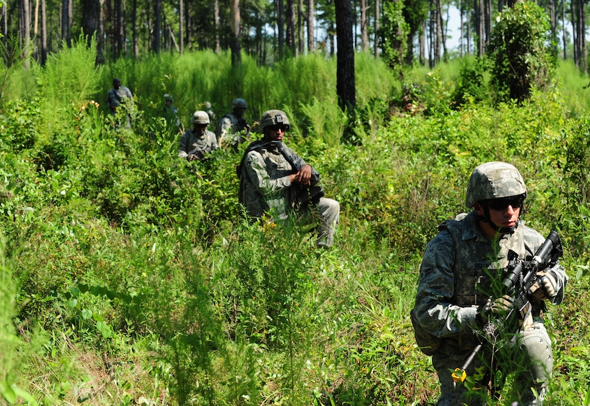 U.S. Air Force Airman 1st Class Jason Casarin, 23rd Security Forces Squadron patrolman, takes cover during a foot patrol at Moody Air Force Base, Ga., Aug. 17, 2011. The patrol was tasked to search for opposing forces during a phase II operational readiness exercise which prepared them to conduct their operations in a deployed location. (U.S. Air Force photo by Senior Airman Stephanie Mancha/Released)