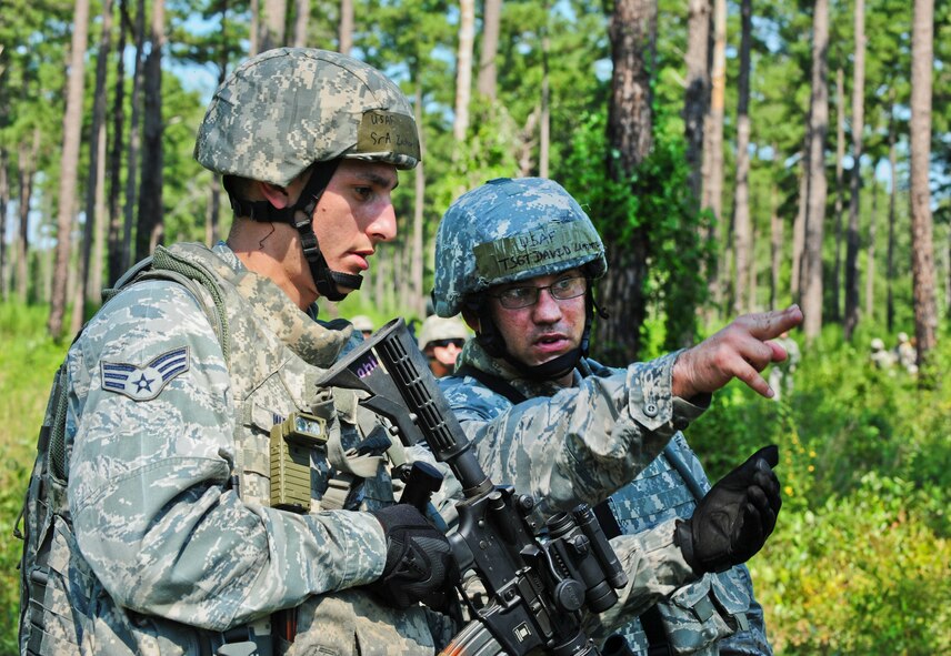 U.S. Air Force Tech. Sgt. David Lamyotte, 23rd Security Forces Squadron squad leader, right, and Senior Airman Zachary Walker, 23rd SFS patrolman, discuss their route through the woods during a phase II operational readiness exercise foot patrol at Moody Air Force Base, Ga., Aug. 17, 2011. During the simulated operation, the 23rd SFS members captured or eliminated all of the opposing forces with minimal injuries of their own. (U.S. Air Force photo by Senior Airman Stephanie Mancha/Released)