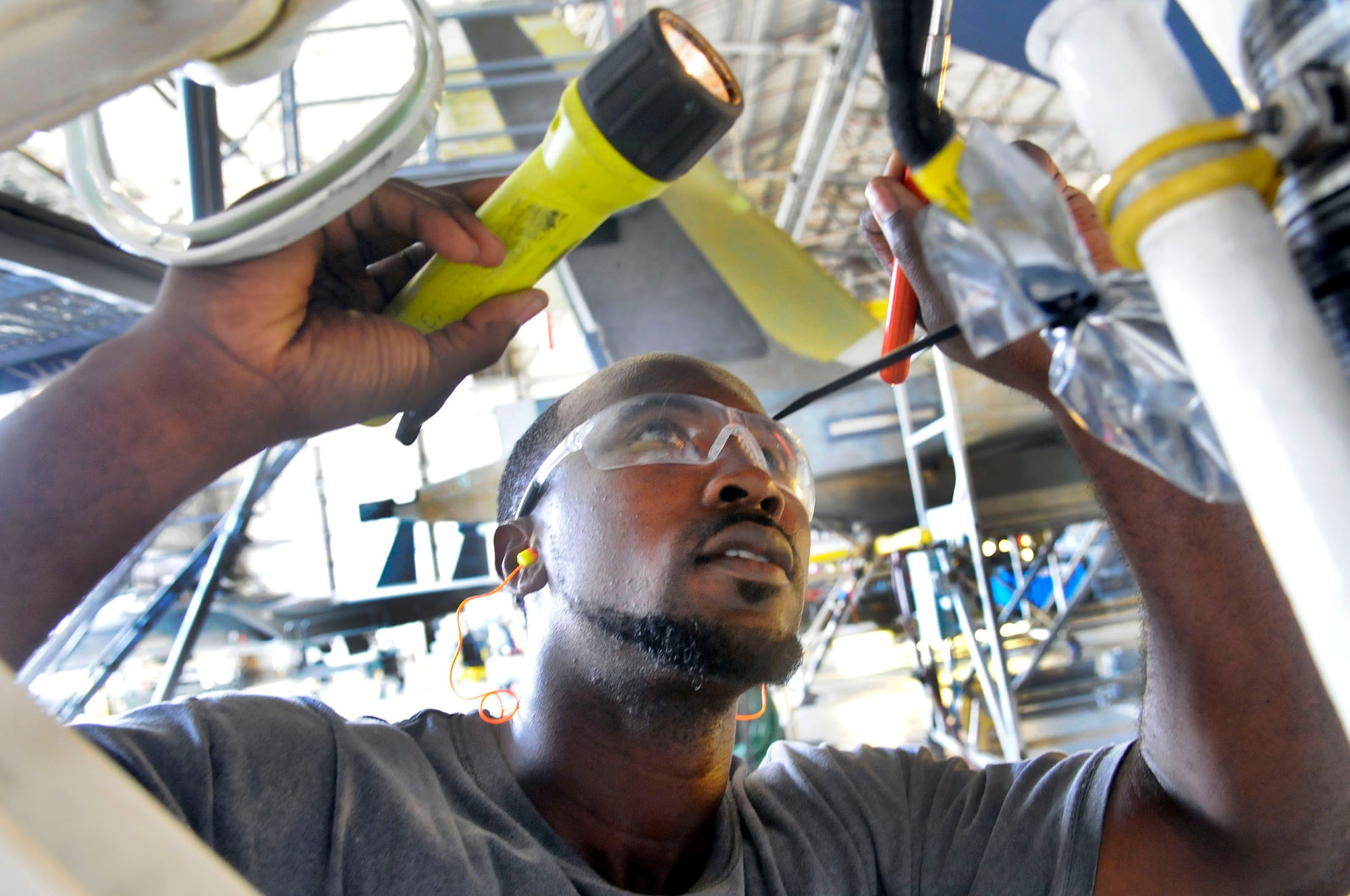 Marquis Wimberly, aircraft mechanic, inspects an F-15 nose landing gear for FOD. Wimberly is one of the workers in the 402nd Maintenance Wing Wage Grade Helper Formal Training Program. U. S. Air Force photo by Sue Sapp