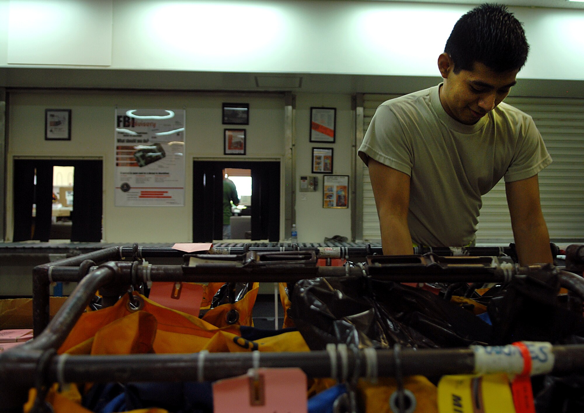 Senior Airman Roy Ramon, a postal specialist with the 18th Communications Squadron, places packages in their assigned places before being mailed inside the base post office Aug. 17 at Kadena Air Base, Japan. Members of the Kadena post office have been working around the clock since Typhoon Muifa delayed thousands of pieces of mail from getting to the base. They have processed more than 3,805 pieces of Express, Letter-Class, Priority and Space Available mail totaling 83,829.5 lbs since the 60-hour typhoon. "The active duty Airmen and local nationals of the post office strive to process and deliver mail to Team Kadena within 24 hours of receiving mail trucks," said Wong. "The post office receives two to three trucks of mail on a daily basis." (U.S. Air Force photo/Senior Airman Sara Csurilla)