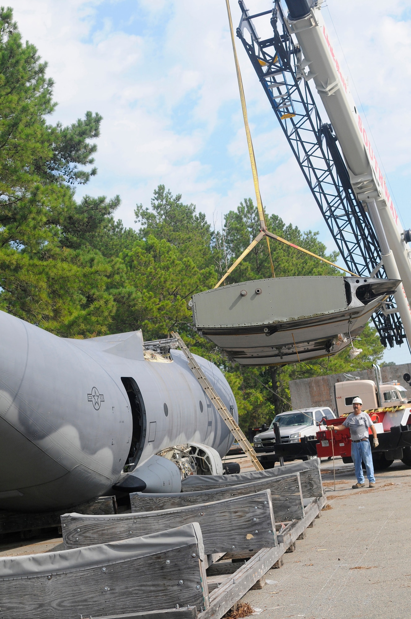 The center wing is removed from a C-27A  Aug11 in preparation for transport of the fuselage. The fuselage  will become the first G222 flight and loadmaster trainer for the Afghanistan Air Force. U. S. Air Force photo by Sue Sapp