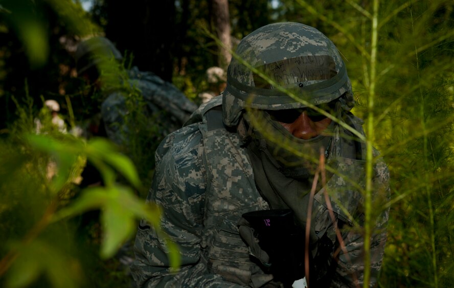 U.S. Air Force Staff Sgt. Ronnie Ward, 23rd Security Forces Squadron patrolman, creeps through a woodland environment while searching for opposing forces during a phase II operational readiness exercise at Moody Air Force Base, Ga., Aug. 17, 2011. The 23rd SFS Airmen operated in three different groups while scanning for opposing forces. (U.S. Air Force photo by Airman 1st Class Joshua Green/Released)
