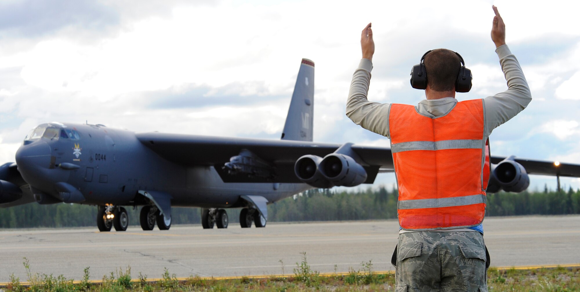 Airman 1st Class Michael Smith marshals a B-52H Stratofortress for take-off during RED FLAG-Alaska 11-3 August 15, 2011, Eielson Air Force Base, Alaska.  The work completed by crew chiefs provide mission capable aircraft for pilots so they can provide air support, serving as a vital role in the overall RED FLAG-Alaska mission.  Airman Smith is a crew chief assigned to the 69th Bomb Squadron, Minot Air Force base, North Dakota.  (U.S. Air Force photo/Staff Sgt. Miguel Lara III)