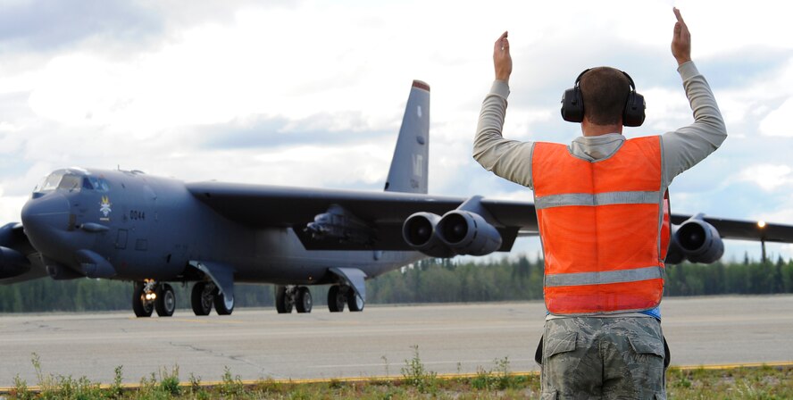 Airman 1st Class Michael Smith marshals a B-52H Stratofortress for take-off during RED FLAG-Alaska 11-3 August 15, 2011, Eielson Air Force Base, Alaska.  The work completed by crew chiefs provide mission capable aircraft for pilots so they can provide air support, serving as a vital role in the overall RED FLAG-Alaska mission.  Airman Smith is a crew chief assigned to the 69th Bomb Squadron, Minot Air Force base, North Dakota.  (U.S. Air Force photo/Staff Sgt. Miguel Lara III)