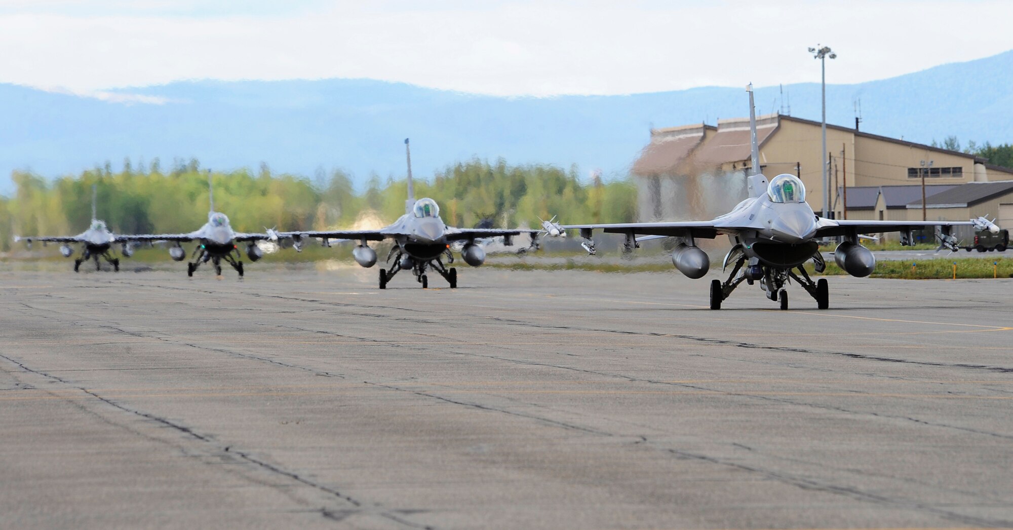Four F-16 Fighting Falcons taxi the runway during RED FLAG-Alaska 11-3 August 15, 2011, Eielson Air Force Base, Alaska.  RF-A, a two week long exercise, focuses on aerial combat training for U.S. and allied forces and is conducted within the Joint Pacific Alaska Range Complex, a 67,000 square mile training range.  The F-16s are from Kunsan Air Base, Republic of Korea. (U.S. Air Force photo/Staff Sgt. Miguel Lara III)