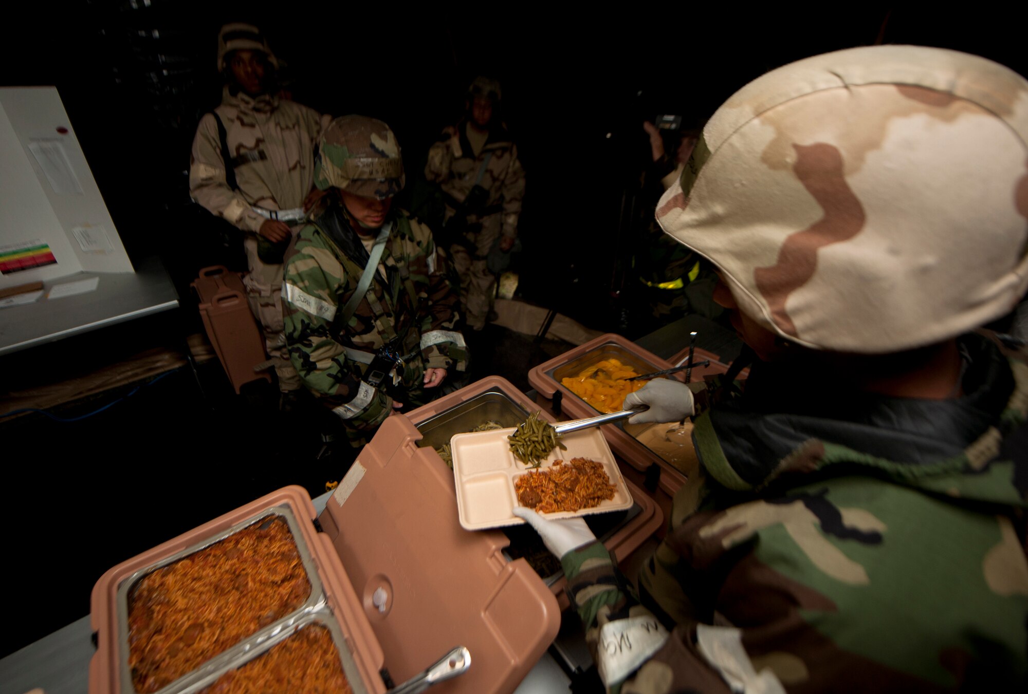 U.S. Air Force Airmen participating in the phase II operational readiness exercise (ORE) receive a tray of food at Moody Air Force Base, Ga., Aug. 16, 2011. Airmen were given the experience of a dining facility in a deployed environment for the first time since the 23rd Forces Support Squadron decided to utilize the capability. (U.S. Air Force photo by Airman 1st Class Joshua Green/Released)
