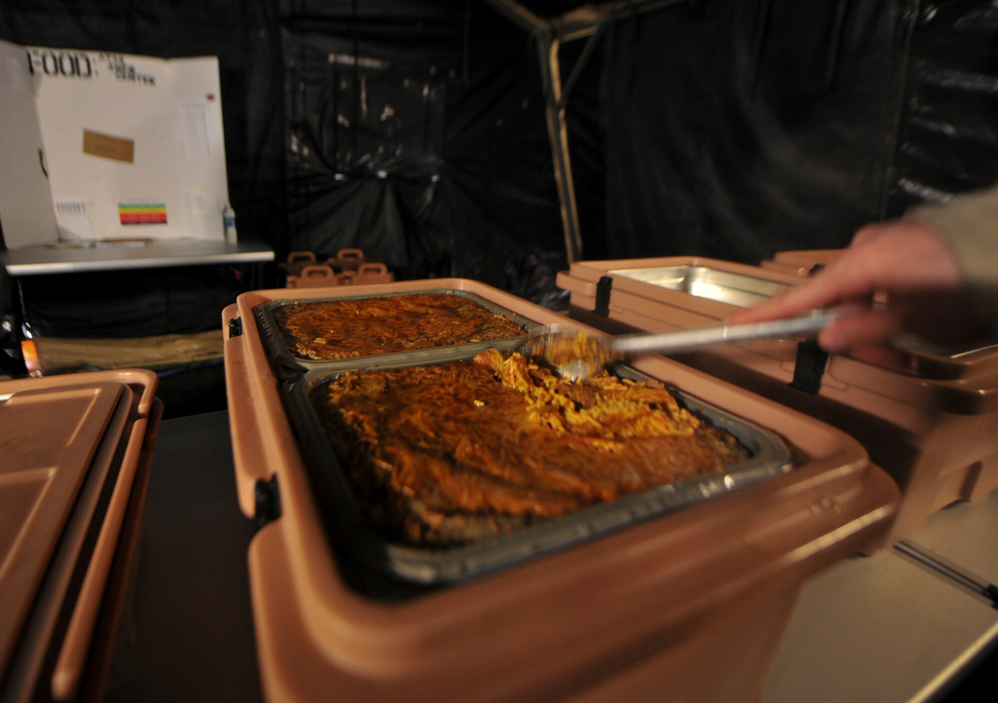 Pans of spaghetti are prepared for Airmen participating in the phase II operational readiness exercise (ORE) at Moody Air Force Base, Ga., Aug. 16, 2011. This is the first time that the 23rd Force Support squadron provided a dining facility for the ORE. (U.S. Air Force photo by Airman 1st Class Joshua Green/Released)
