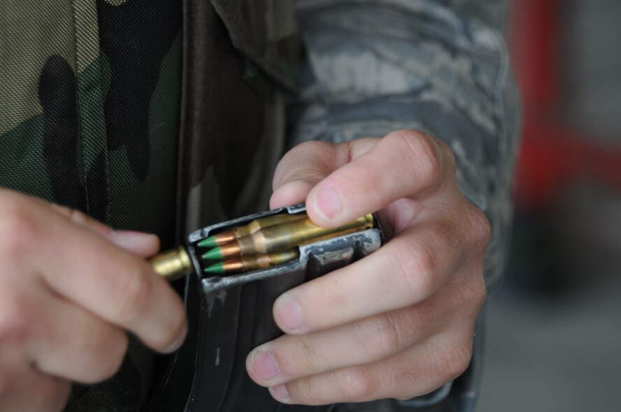 A member of the 126th Civil Engineering Squadron loads a magazine during weapons qualification training with the M-4 rifle at Vandenberg Air Force Base, Cali. The Illinois Air National Guard squadron, from Scott Air Force Base, Ill., is in California doing two weeks of annual training at Camp Roberts. The Army National Guard training base was created in 1941 to support troops leaving for World War II and is now in need of repairs to buildings and infrastructure. Air National Guard Civil Engineering squadrons, known as "Prime Beef" units when deployed, are using the opportunity to train on real world electrical, structural, plumbing and heavy equipment scenarios. This creates a  collaboration that proves valuable to both National Guard components.