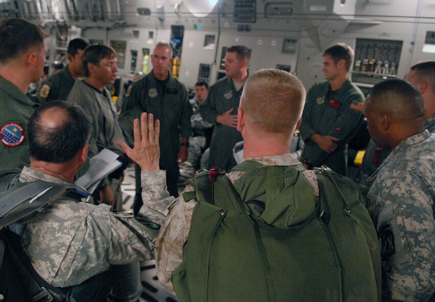 Staff officers and a Marine from the Special Operations Command, Pacific, prepare for static and HALO (high altitude-low opening) jumps out of a U.S. Air Force C-17 from Joint Base Pearl Harbor-Hickam, Hawaii, Aug. 11. SOCPAC is headquartered at Camp Smith, Hawaii. U.S. Navy Capt. Jeffrey James, pictured, was flying with the 535th Airlift Squadron aircraft and crew as part of his orientation as the new joint base commander. (U.S. Air Force photo/Staff Sgt. Carolyn Herrick)