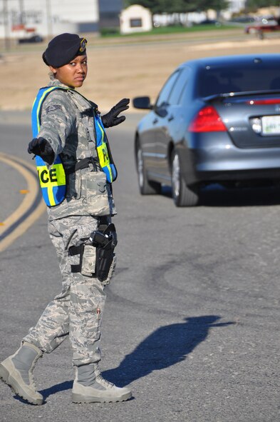 Staff Sgt. Shamika Beckley, 60th Security Forces Squadron patrolman, directs traffic at a tactical point Aug. 17 outside Travis Elementary School during the first day of school. (U.S. Air Force photo/Staff Sgt. Timothy Boyer)