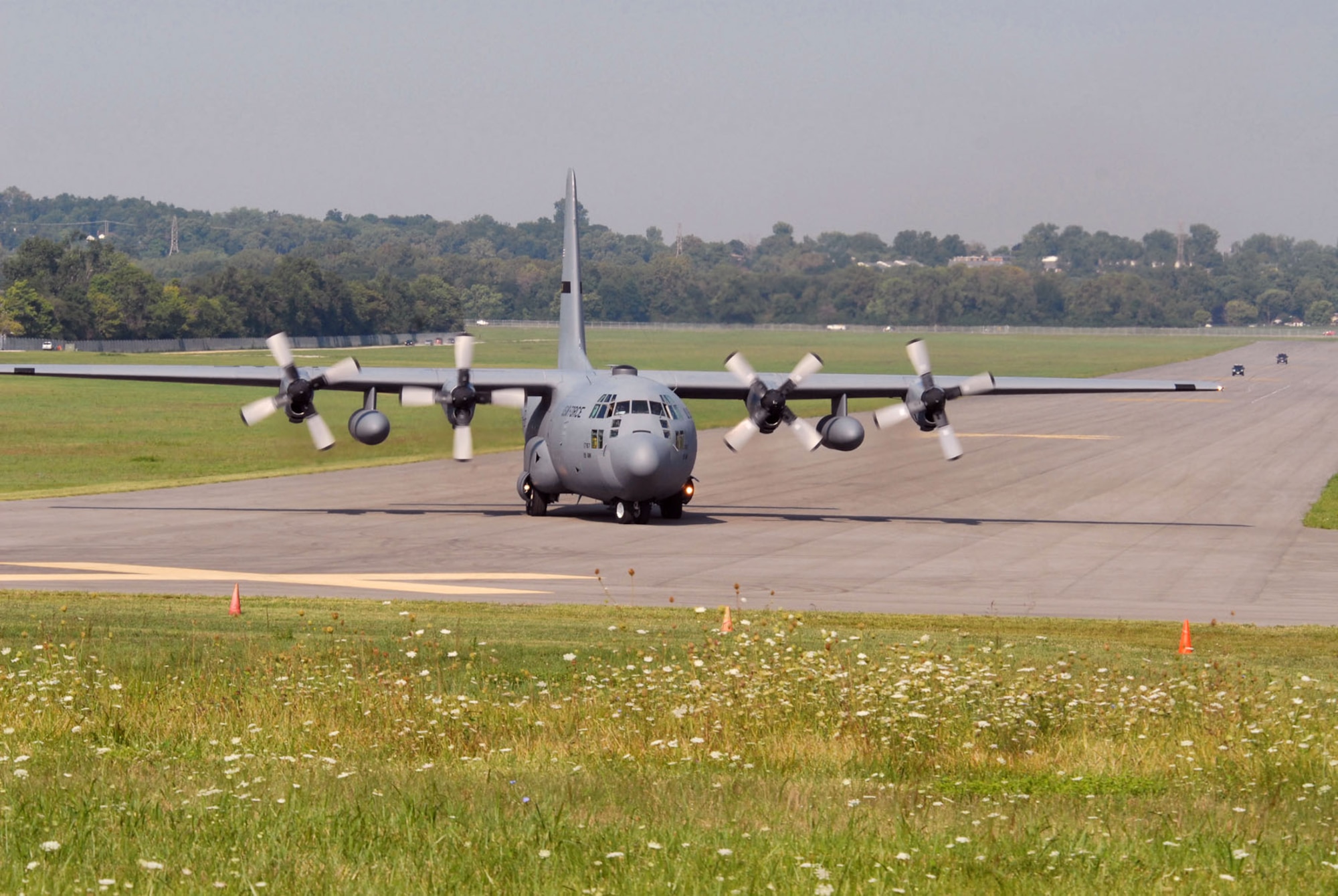 DAYTON, Ohio -- The C-130E SPARE 617 arrives at the National Museum of the U.S. Air Force after its final flight on Aug. 18, 2011. Not only is this C-130E (S/N 62-1787) representative of all C-130 transport aircraft, it also performed courageous work during the Southeast Asia War. Two members of its crew – Capt. William Caldwell, pilot, and Tech. Sgt. Charlie Shaub, loadmaster – were awarded Air Force Crosses, the U.S. Air Force’s second highest award for valor, for their heroic actions during the siege of An Loc in 1972. (U.S. Air Force photo by Jeff Fisher)