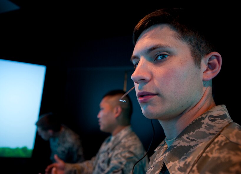 U.S. Air Force Airman 1st Class Glenn Strickland, 23rd Operations Support Squadron air traffic controller apprentice, reviews settings on a Tower Simulator System at Moody Air Force Base, Ga., Aug. 18, 2011. Strickland has been training at Moody for nearly a year, which is typically the amount of time it takes for a new controller to become qualified. (U.S. Air Force photo by Staff Sgt. Jamal D. Sutter/Released)